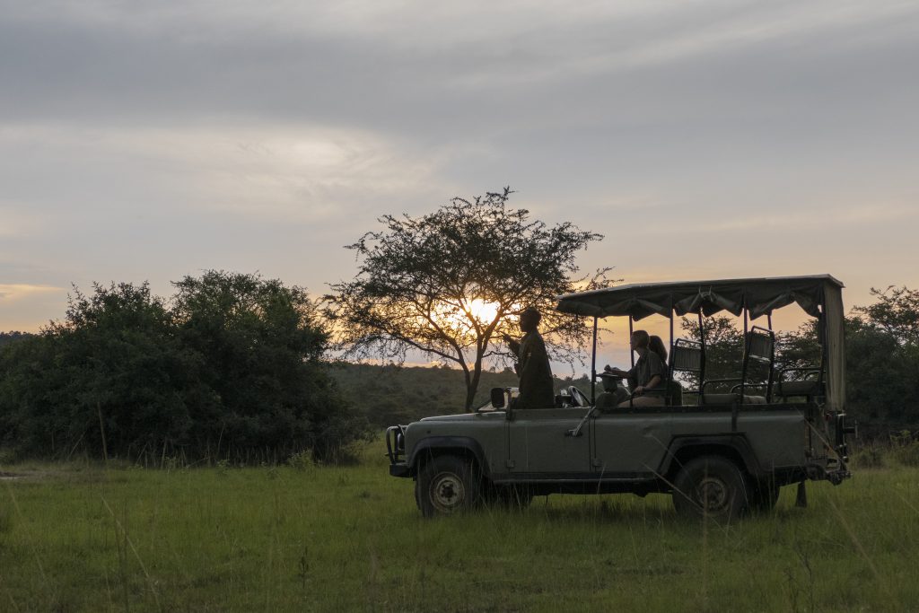 Guests on a Lake Mburo night game drive, which sets off in the evening in Lake Mburo National Park, Uganda
